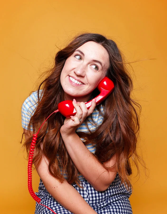 Laura on a red phone